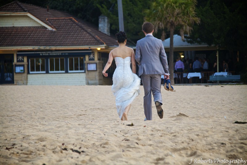 Couple walking on beach - wedding photography
